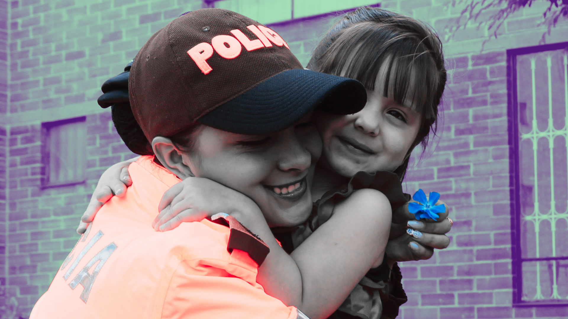 Policewoman hugs a little girl.